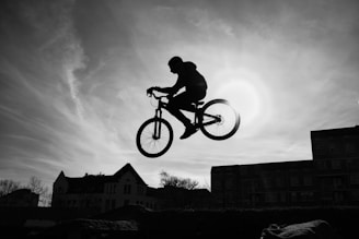a man riding a bike through the air