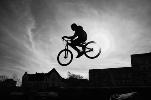 a man riding a bike through the air