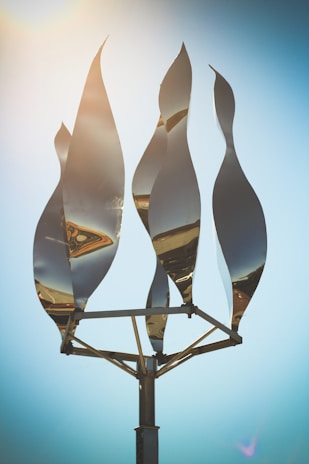 A vibrant metal sculpture reflecting sunlight.
