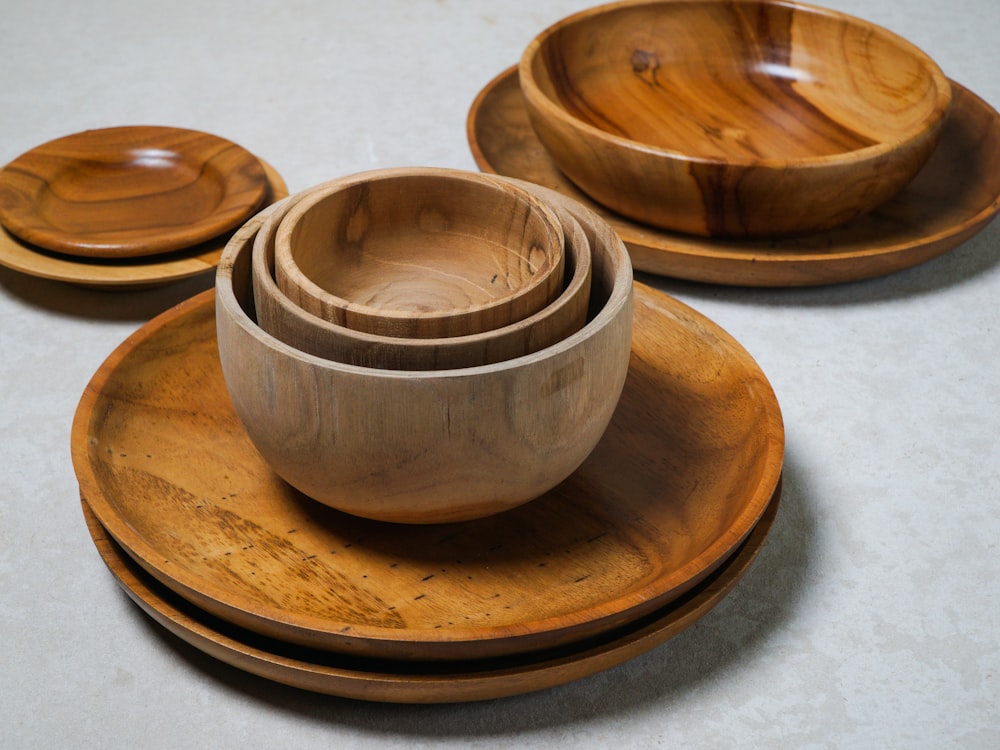 a group of wooden bowls and plates on a table