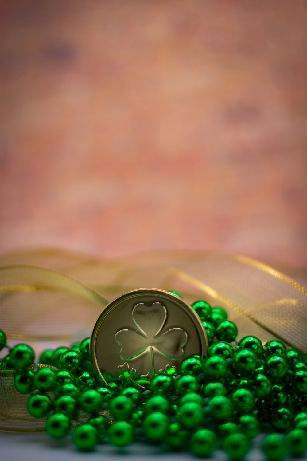 a green beaded necklace with a shamrock on it