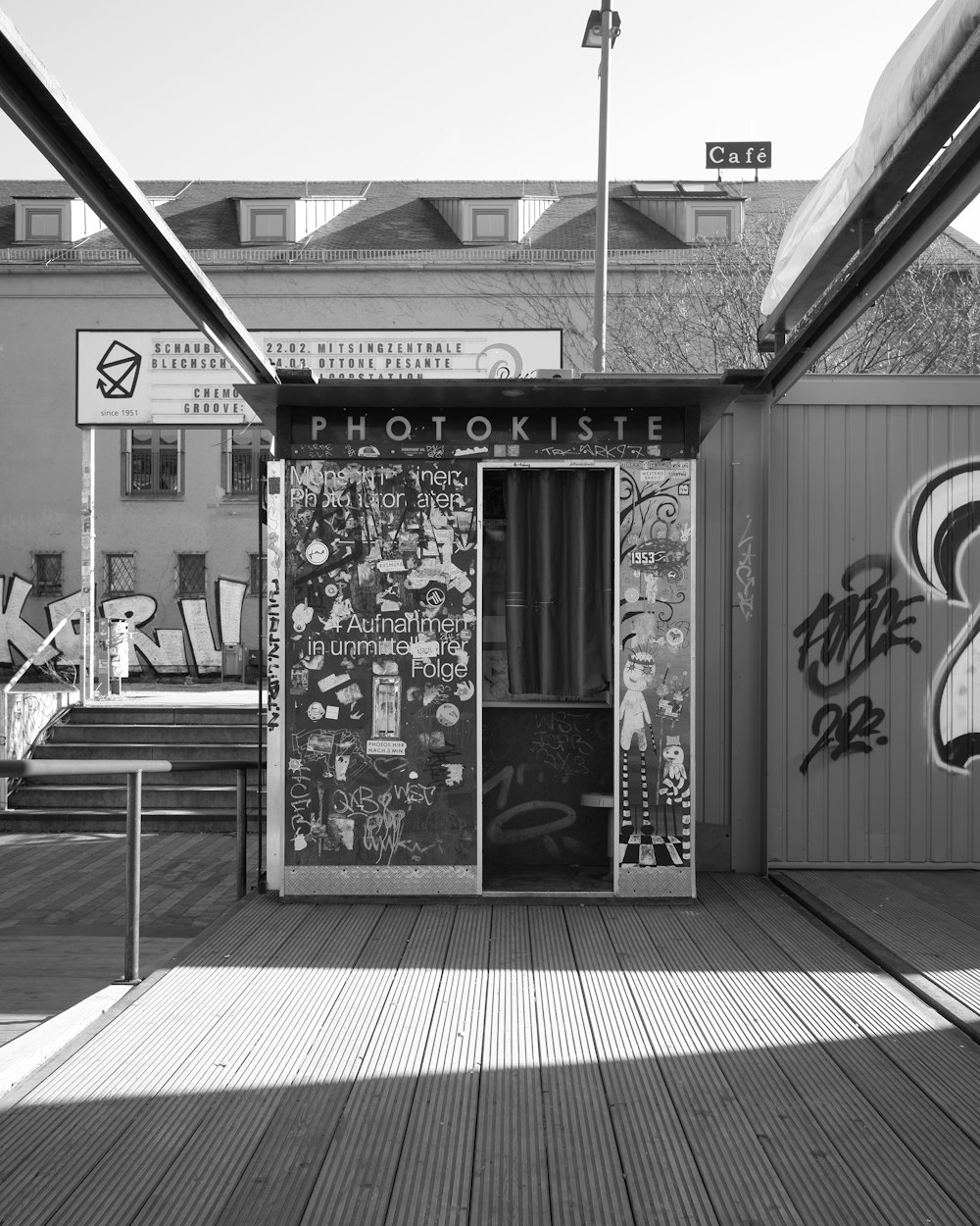 a black and white photo of a building with graffiti on it