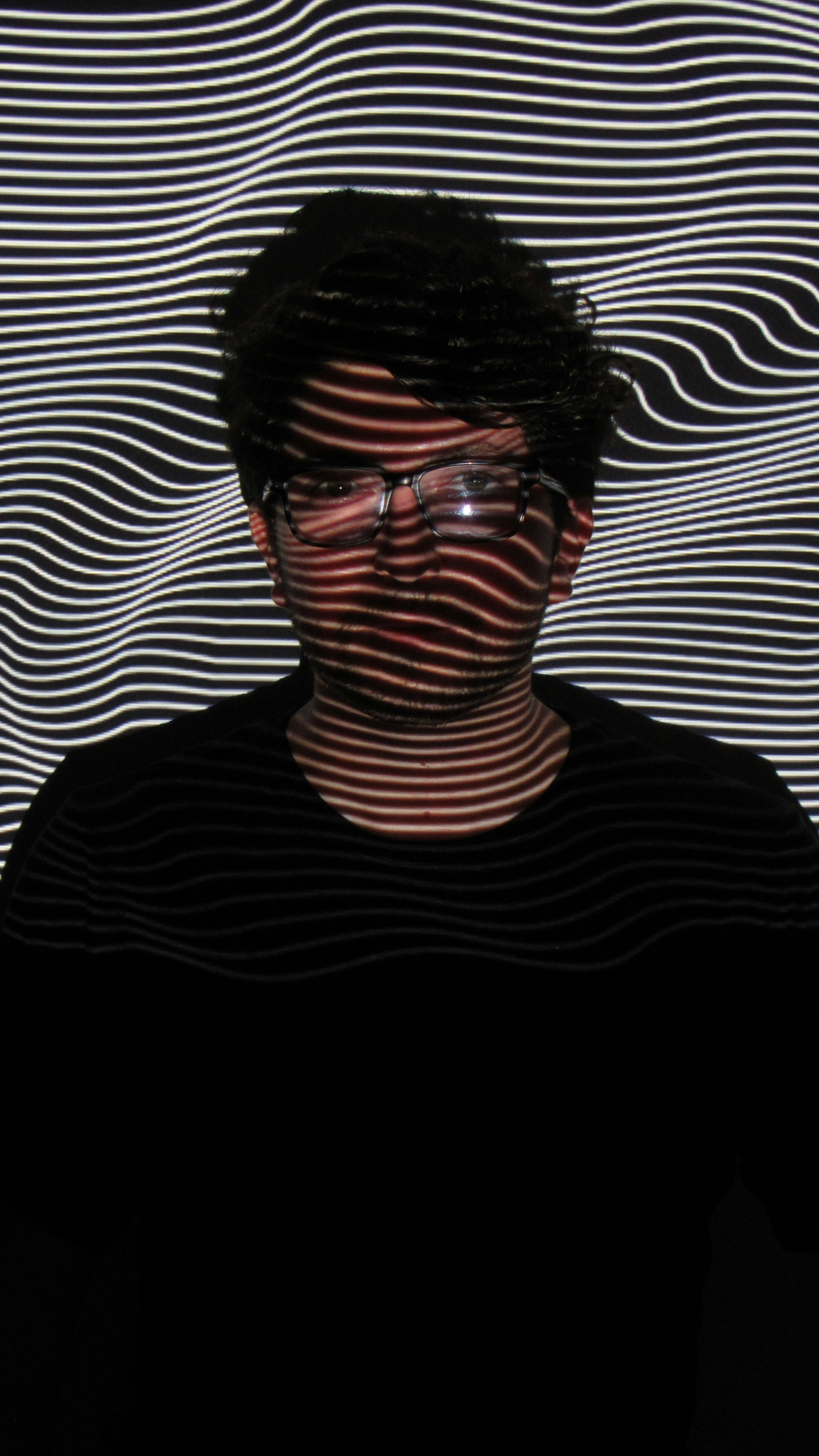 a man with glasses and a black shirt