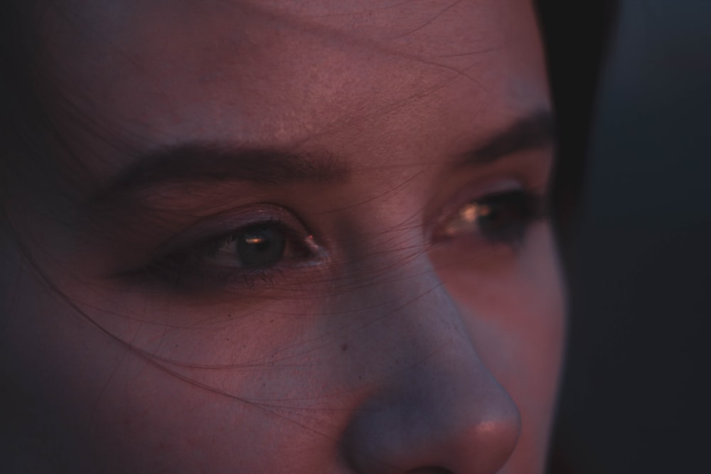 a close up of a woman's face with a blurry background