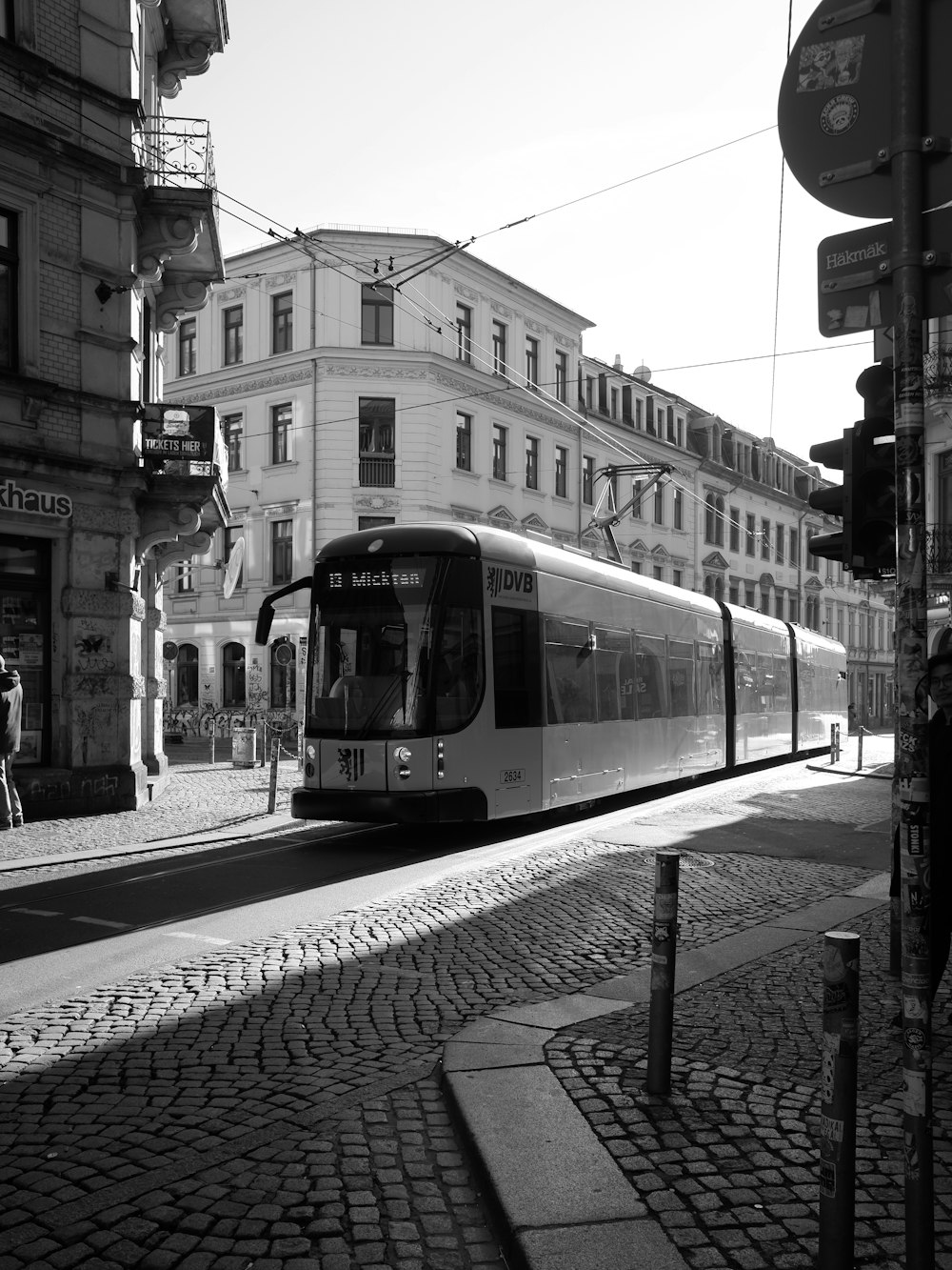 a black and white photo of a train on a street