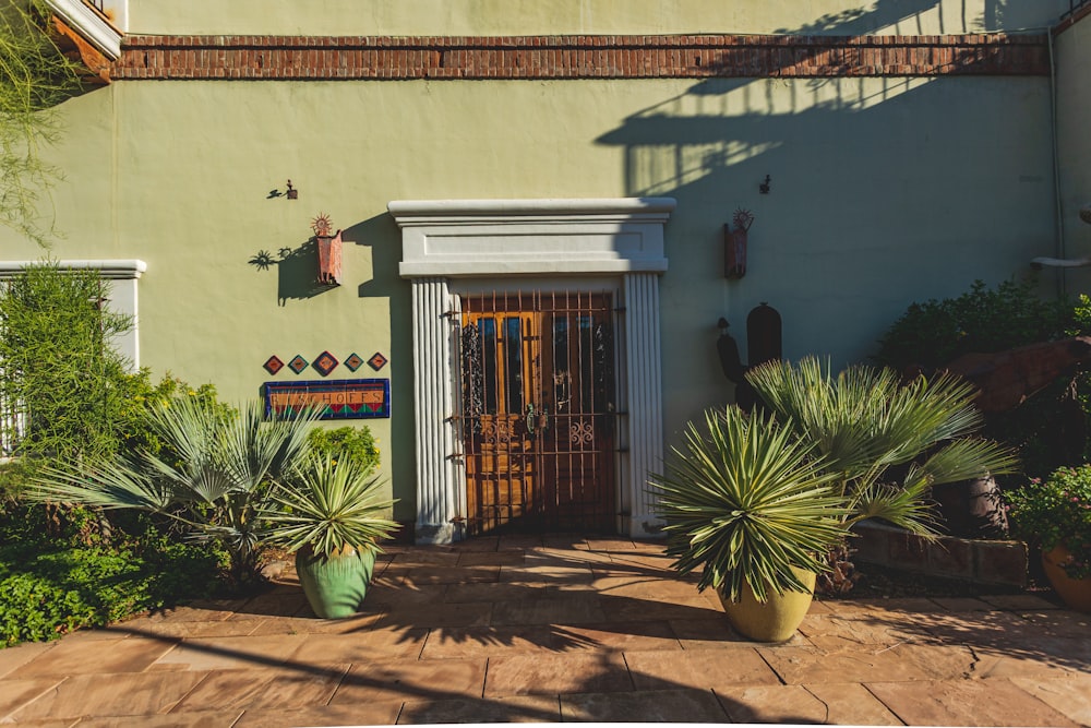 a house with a door and some plants in front of it