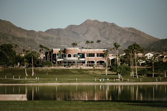a large building with mountains in the background