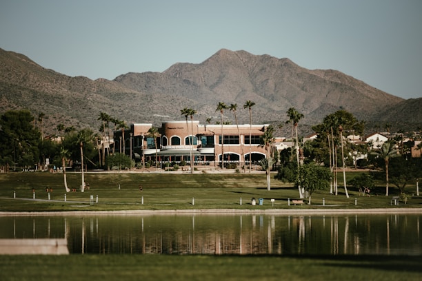 a large building with mountains in the background