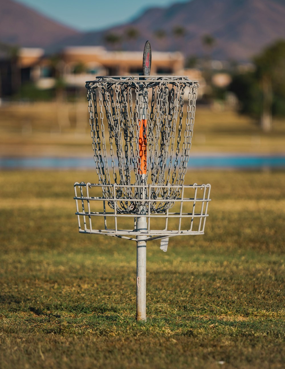 a frisbee golf basket in the middle of a field