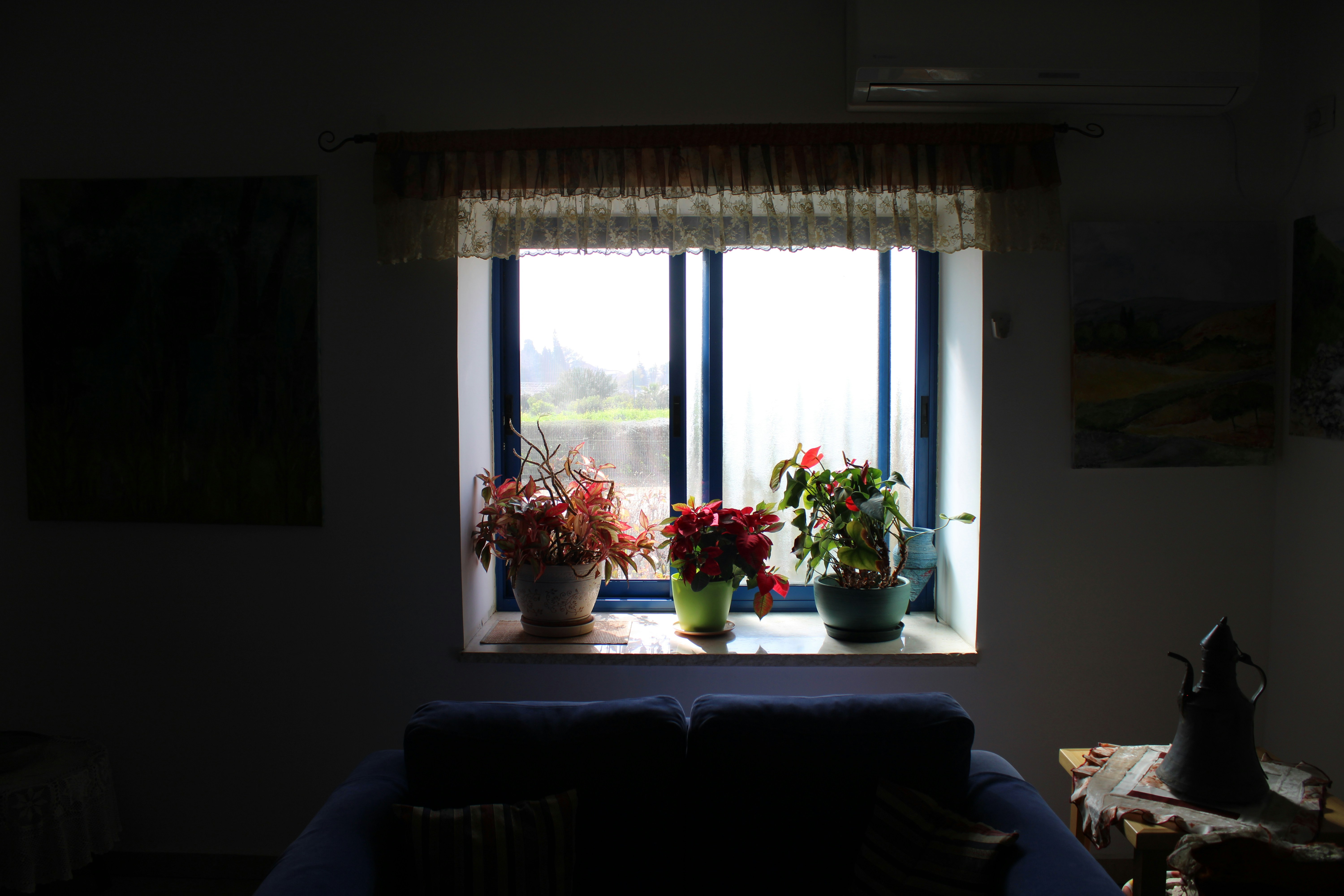 a living room filled with furniture and a window