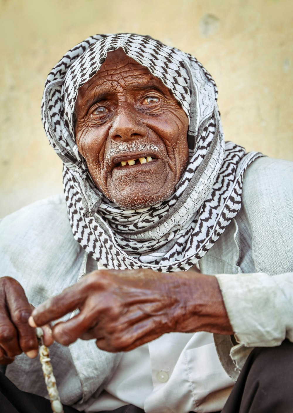 an old woman is holding a stick in her hand