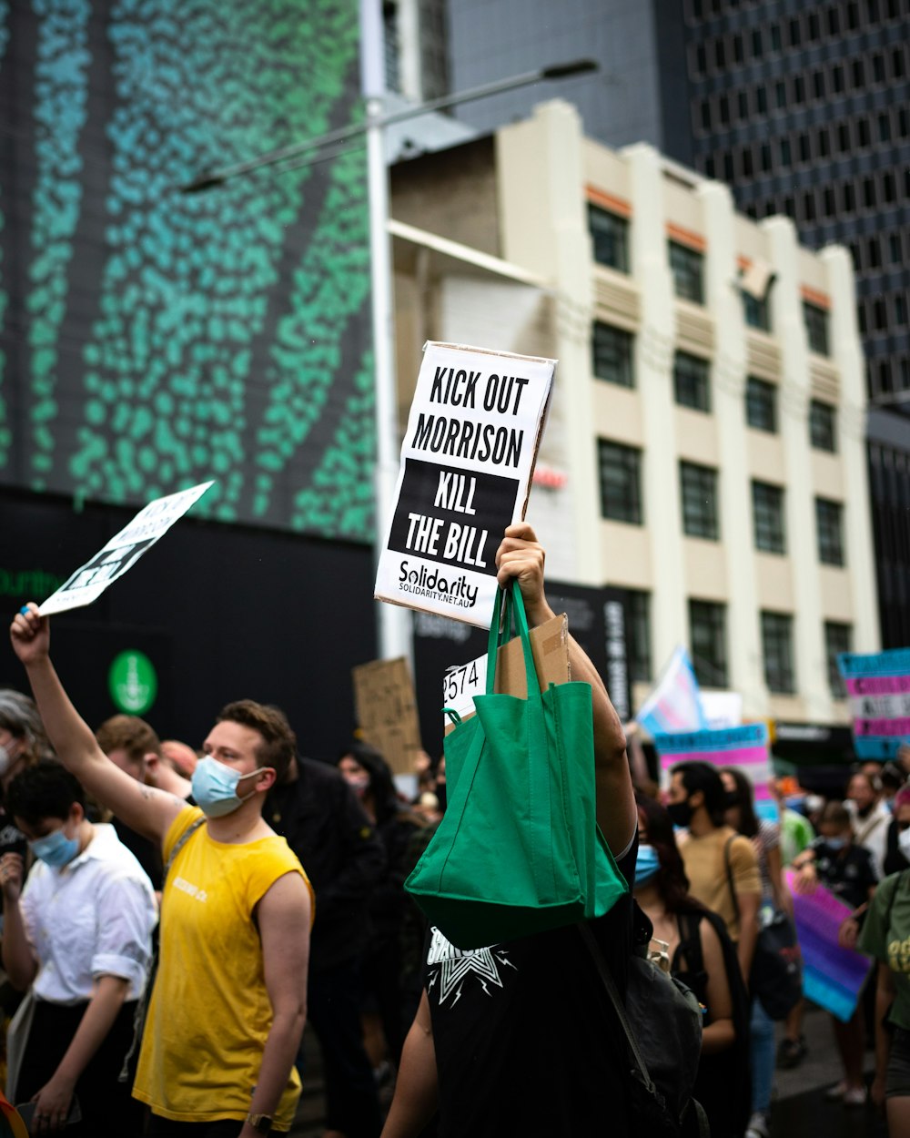 a group of people holding up signs in the air