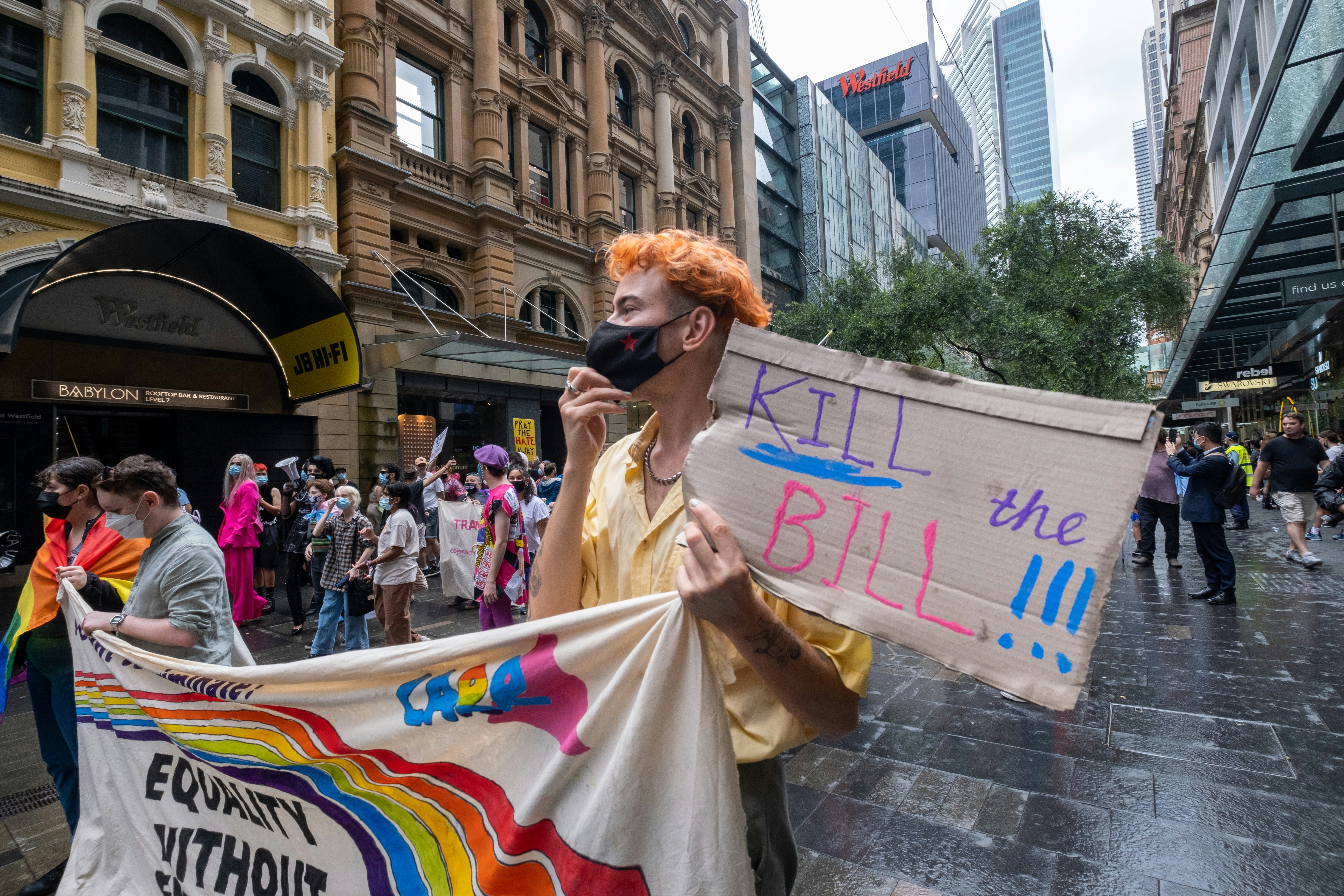 a man with red hair holding a protest sign