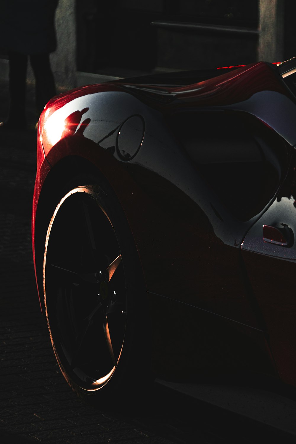 a red sports car parked on the side of the road