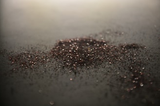 Close-up of clear polymer granules glistening under soft light.