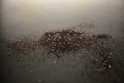 Macro shot of fine diamond powder scattered on a reflective surface