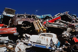 a pile of old cars sitting next to each other