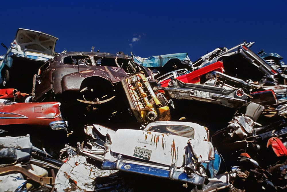 a pile of old cars sitting next to each other