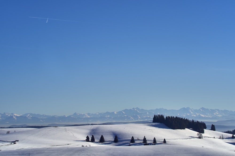 a plane flying over a snow covered mountain range