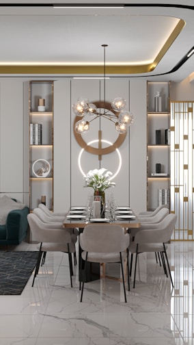A modern dining room with a long table set for six, featuring elegant minimalist chairs and a striking geometric chandelier with spherical bulbs. The room has built-in shelving units with decorative items and books, and a comfortable green sofa with a geometric rug on the side. The floor is glossy marble with a subtle pattern, adding a touch of luxury.