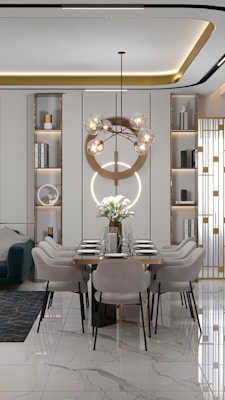A modern dining room with a long table set for six, featuring elegant minimalist chairs and a striking geometric chandelier with spherical bulbs. The room has built-in shelving units with decorative items and books, and a comfortable green sofa with a geometric rug on the side. The floor is glossy marble with a subtle pattern, adding a touch of luxury.