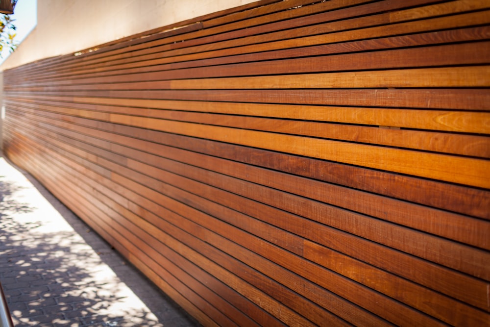 a close up of a wooden slatted fence
