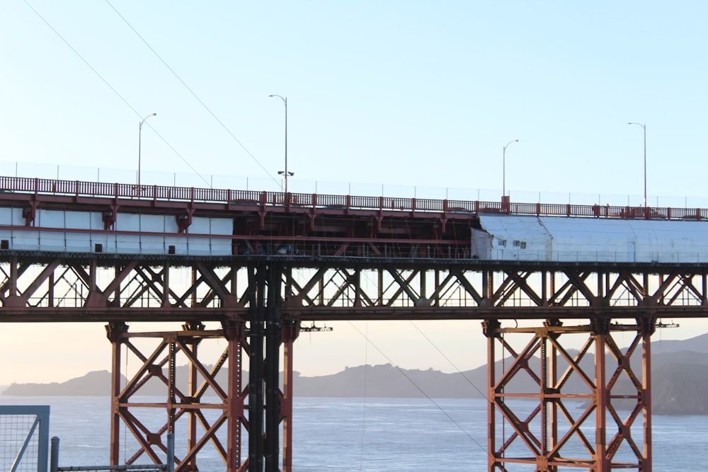 a train traveling over a bridge over a body of water