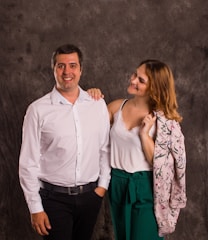 A smiling agent explaining insurance options to a couple.