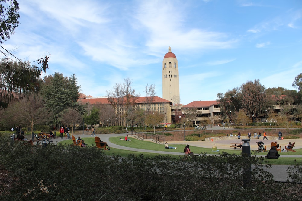 a group of people sitting on a bench in a park