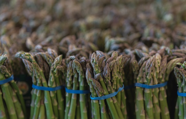a bunch of asparagus wrapped in blue ribbon