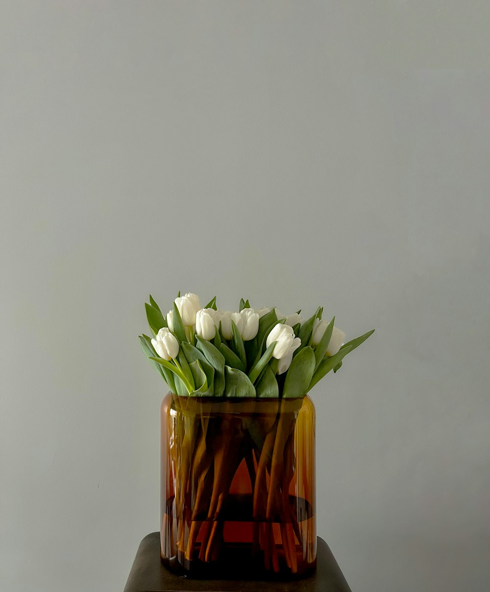 a vase filled with white flowers on top of a table