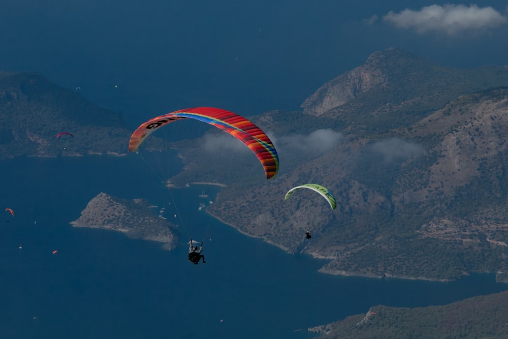 a couple of people parasailing over a body of water