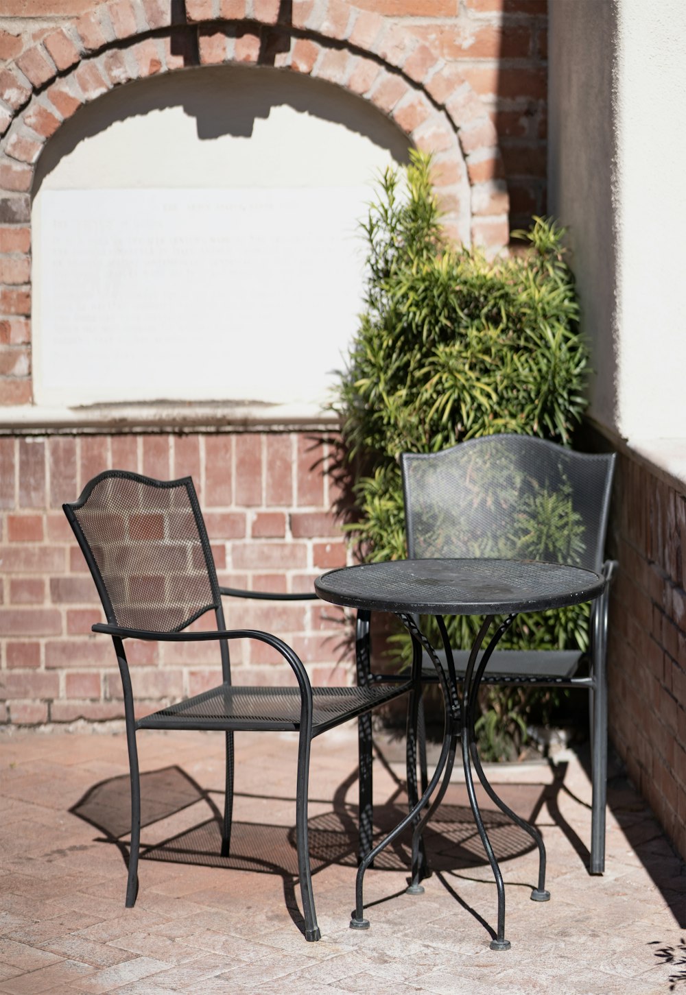 two chairs and a table on a patio