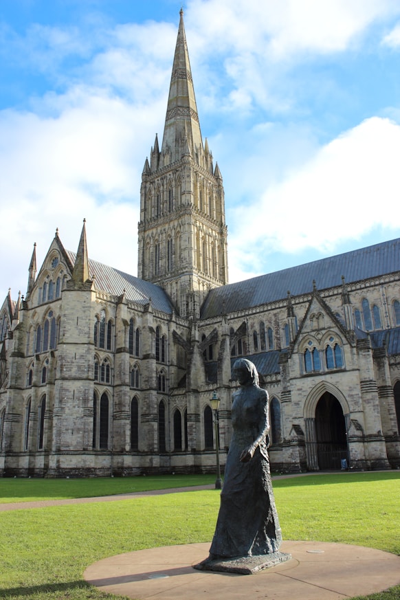 a statue of a woman in front of a large building