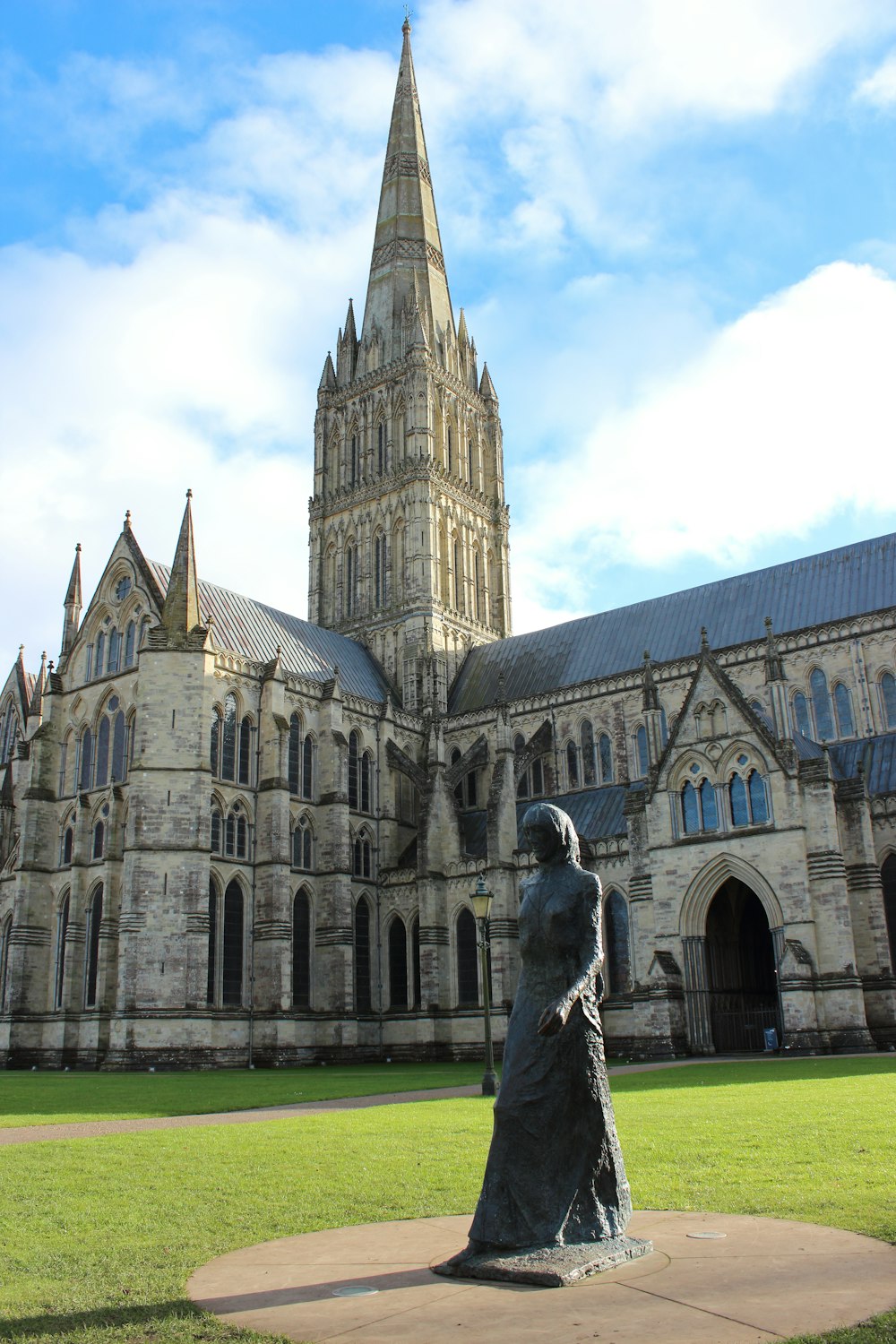 a statue of a woman in front of a large building