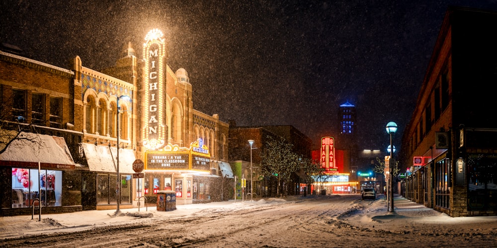 a city street is covered in snow at night