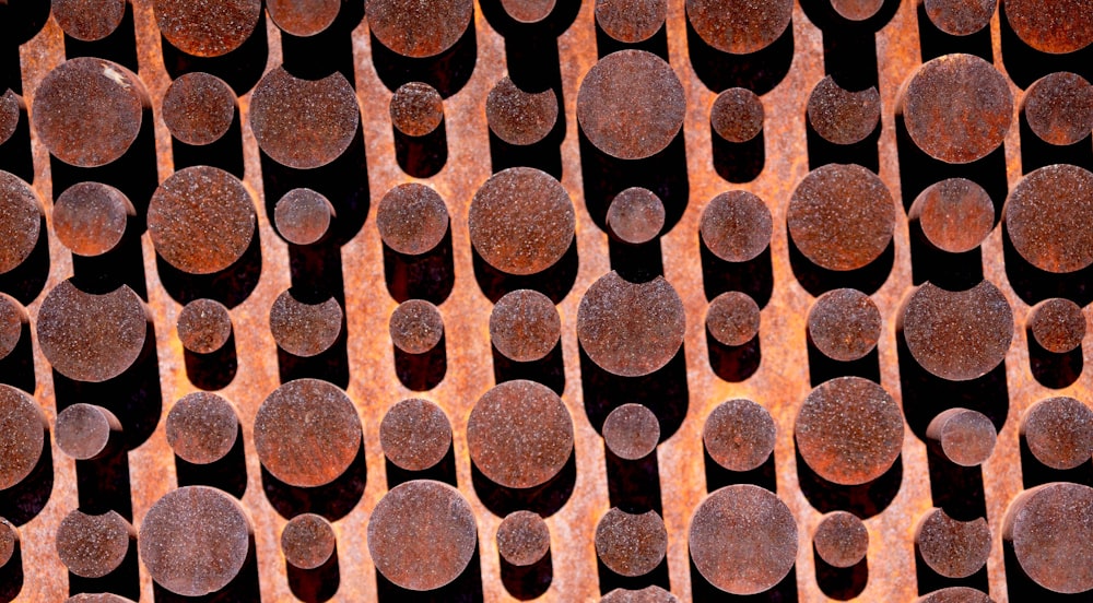 a close up of a metal grate with circles on it