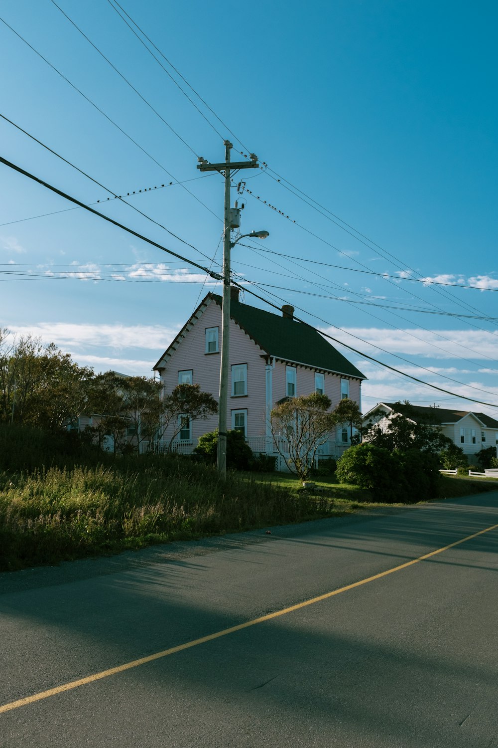 a pink house on the side of the road