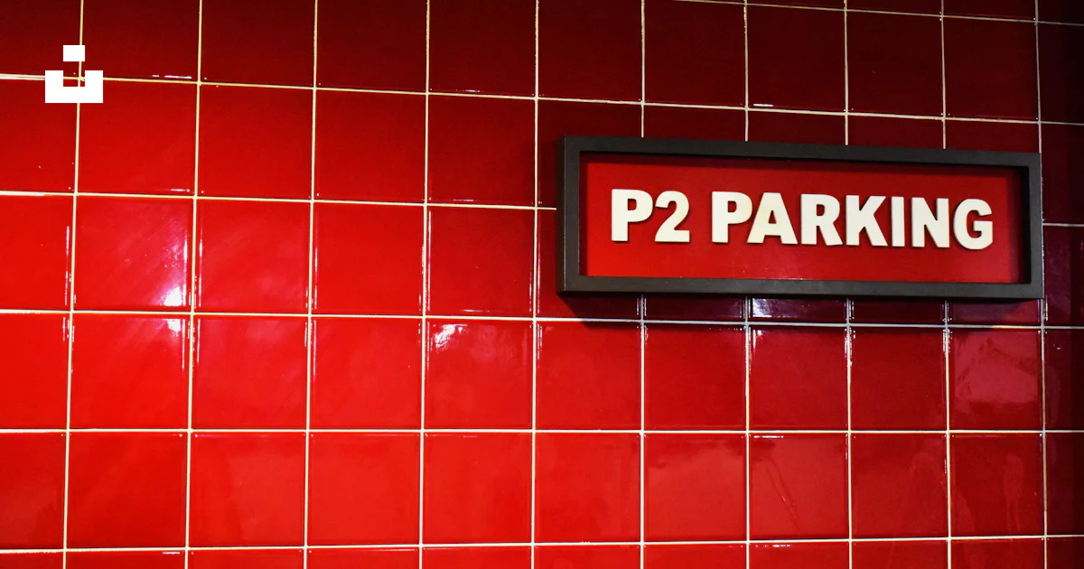A red tiled wall with a sign that says p2 parking photo – Free Tile ...