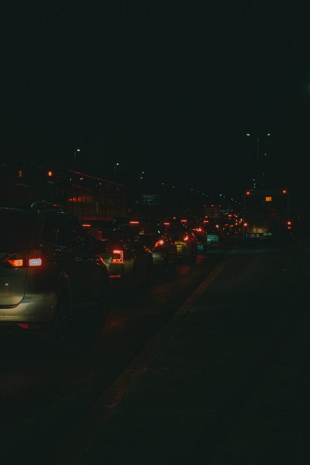 a city street filled with lots of traffic at night