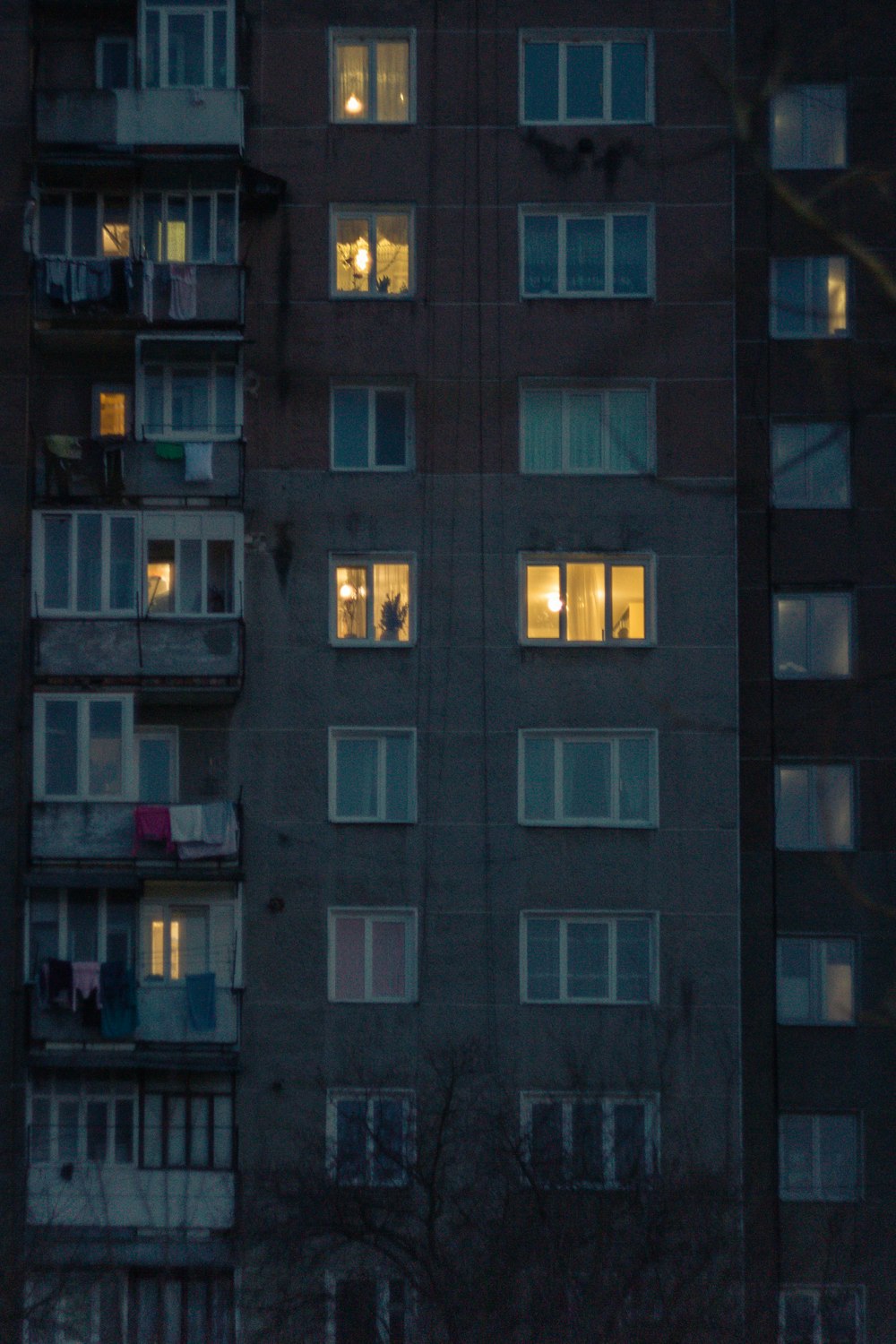 a tall building with lots of windows at night