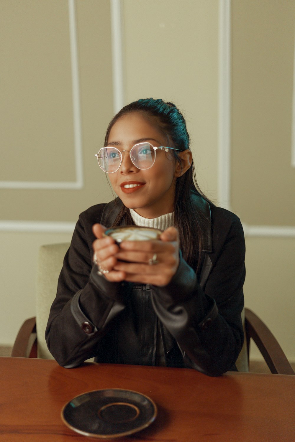 a woman sitting at a table with a plate of food