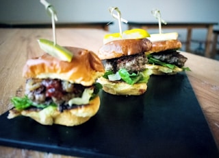 a couple of sandwiches sitting on top of a wooden table