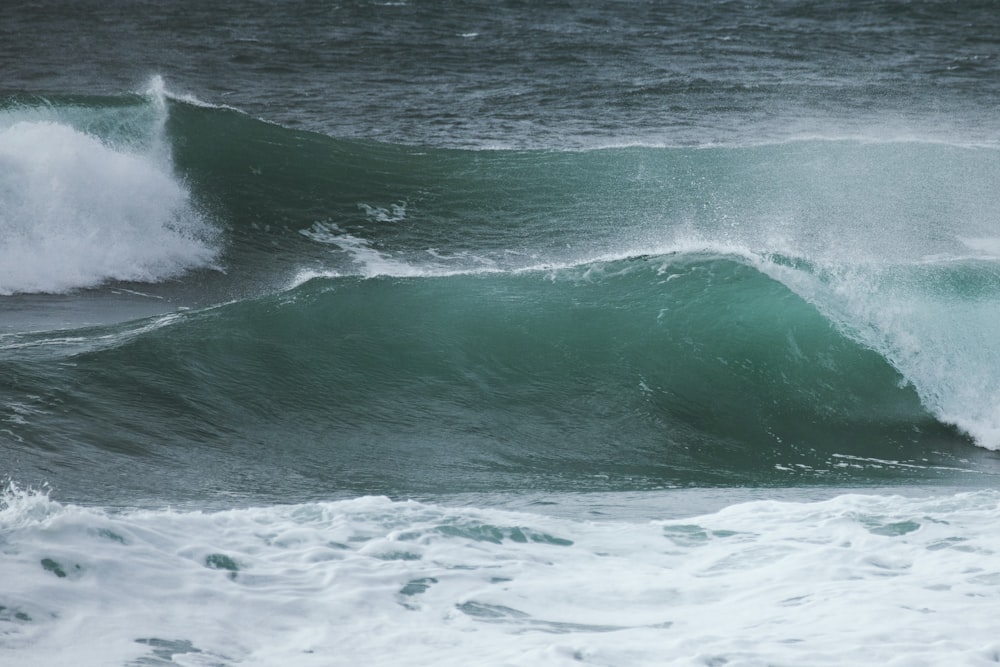 a man riding a wave on top of a surfboard