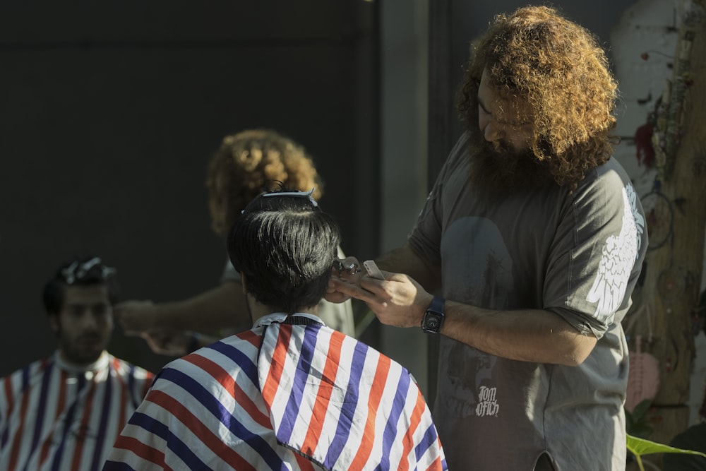 a man getting his hair cut at a barber shop