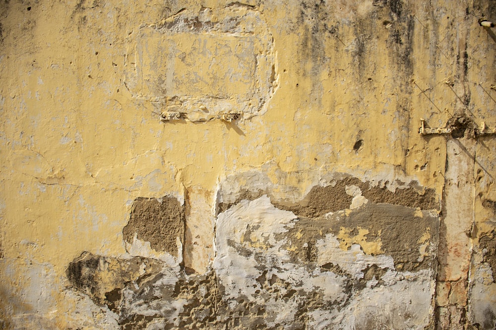 an old wall with peeling paint on it