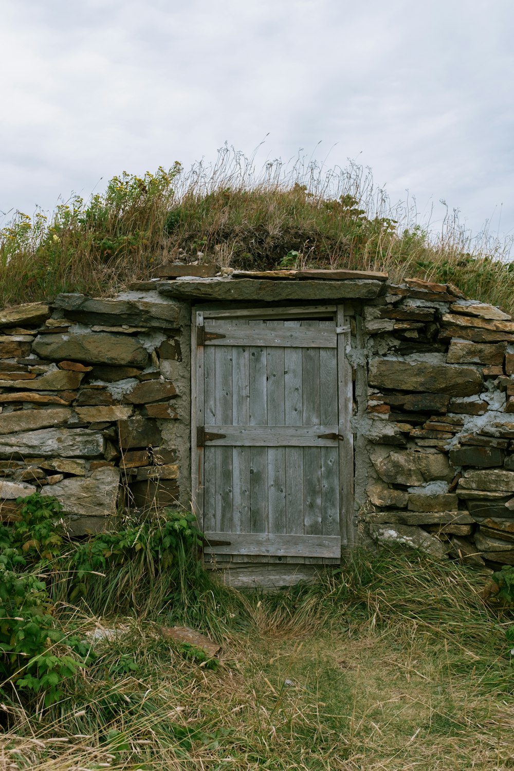 an old stone building with a wooden door