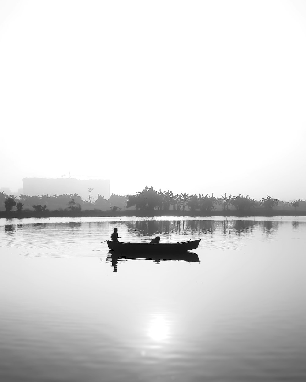 a person in a small boat on a large body of water