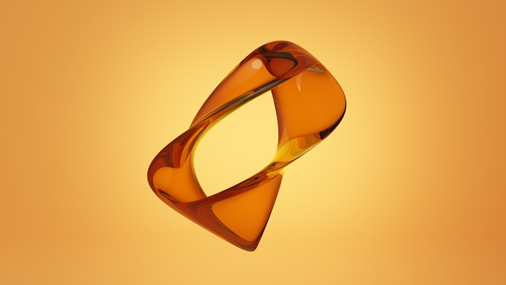 a glass object floating in the air on a yellow background