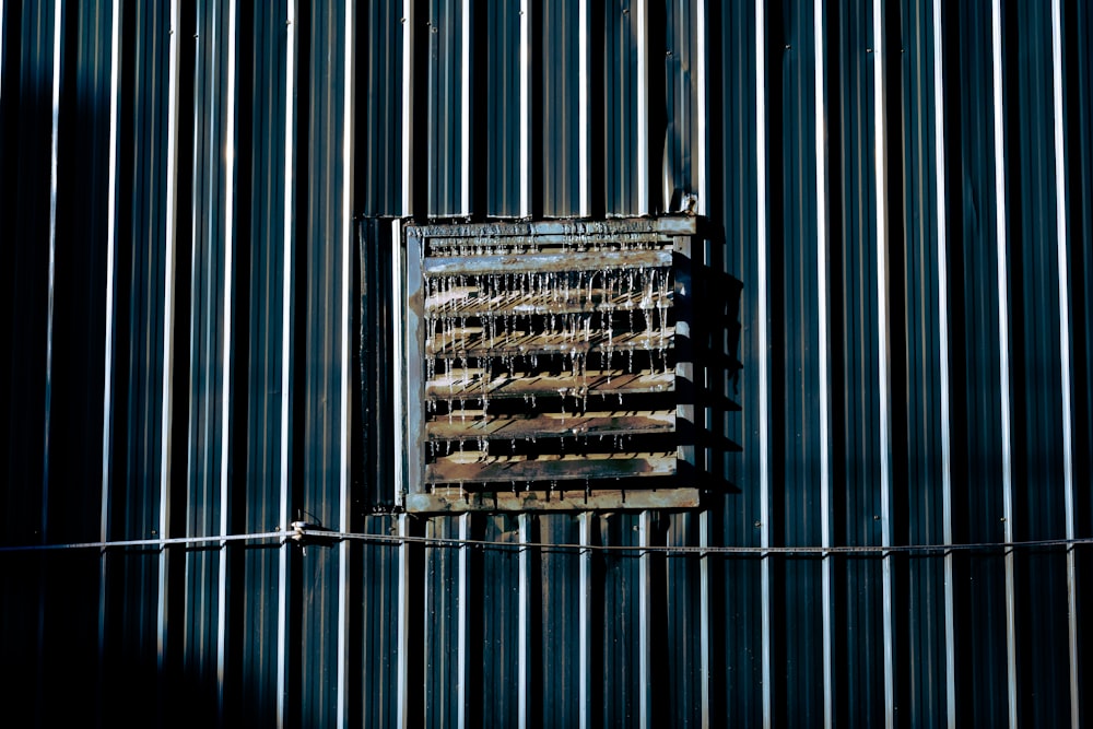 an old rusty metal door on the side of a building